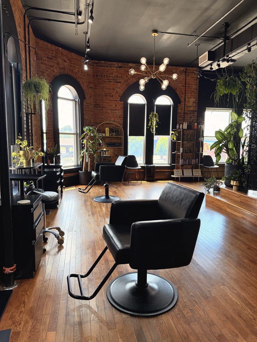 Black styling chair beneath arched windows in the NUYU studio